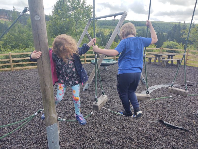 Kids playing on an assault course on a rare day out